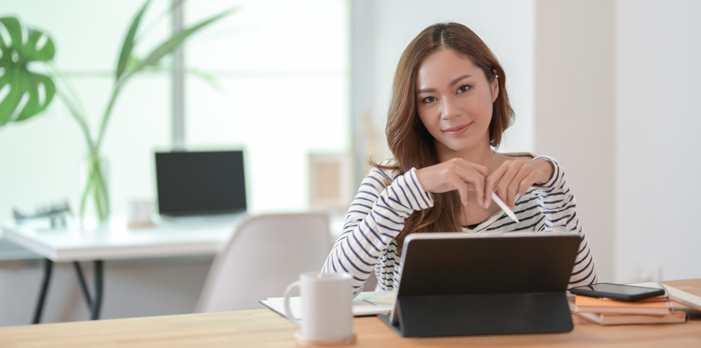 Asian woman with tablet working on project